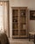 Four shelves, entirely visible. A ball-foot base that lifts the piece just enough to breathe. This antique Indian teak...