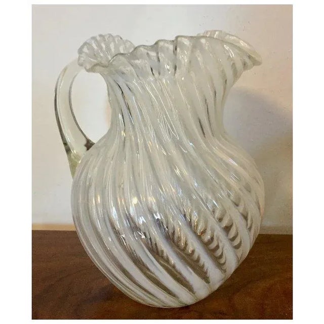Antique 19th c. American opalescent white swirl glass pitcher with ruffled rim. Applied handle and polished pontil on the...