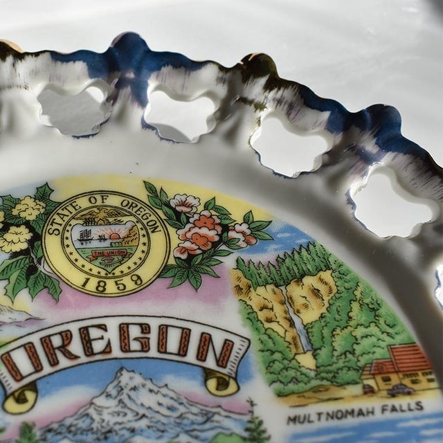 Unique ceramic circular blue and gold souvenir plate from Oregon. This beautiful plate is round in form, and features...