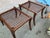 Pair of Robsjohn Gibbings style ottomans. The ottomans are in good condition. The wood has a walnut stain. Leather cording...
