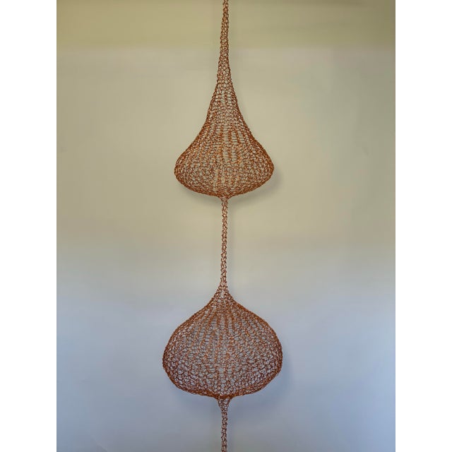 A striking monumental handwoven copper wire hanging sculpture in the style of Ruth Asawa, showcasing the delicate...