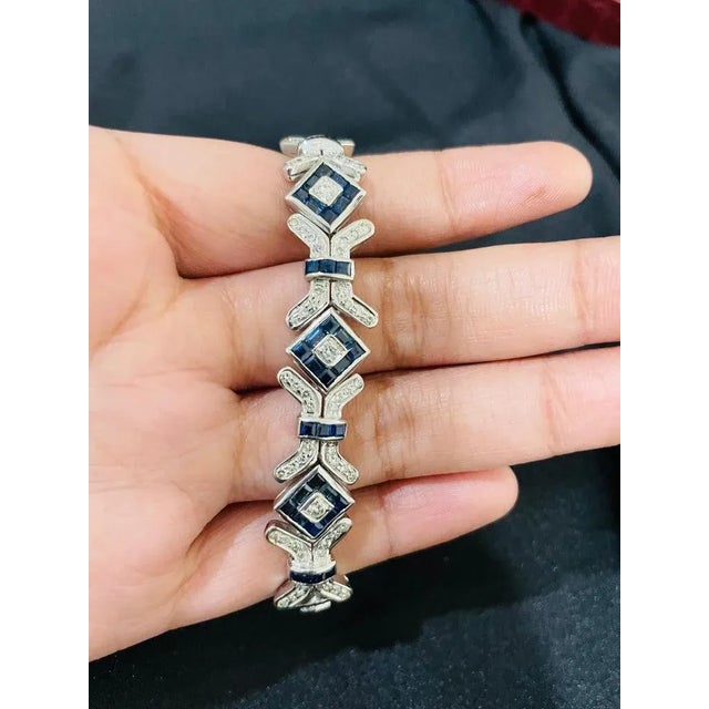 This is part of Chairish’s Fine Jewelry assortment. This Art Deco Style Diamond and Blue Sapphire Bracelet in 18K gold...