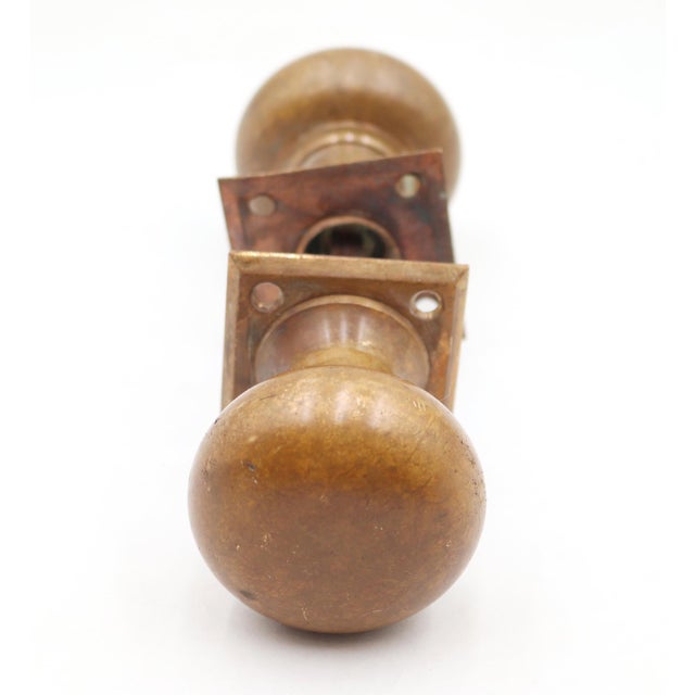 Traditional style warm finish brass passage door knob set. The original mounting screws are not available. Priced as two...