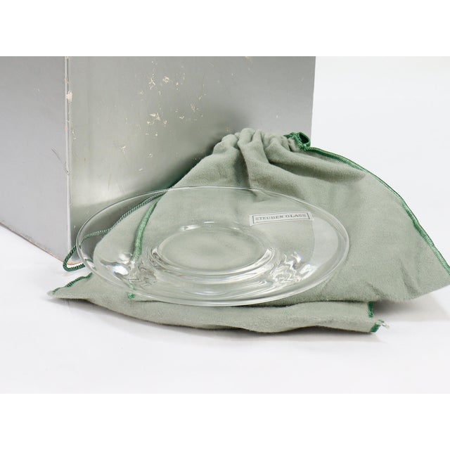 A fine set of glass plates. By Steuben. In clear glass. Pattern No. 7644. Each plate slightly recessed plate and with a...