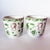 Lovely pair of porcelain cache pot planters, mid century, with green bird motifs and gilt lions head handles. They have...