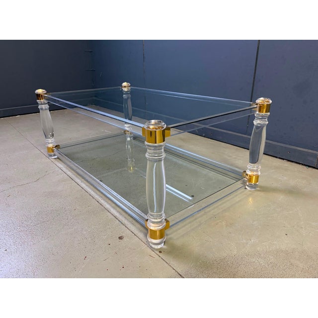 Vintage coffee table with an acrylic frame, brass corners and two glass plates. Good condition. Very modern looking and...