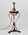 Lamp consisting of a black cast iron and copper base, and a removable, rounded copper lamp mounted on three small brass...