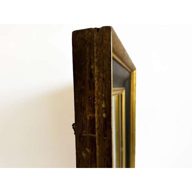 Here is a stunning antique mirror attributed to the 1890s American Empire design style. The handsome mahogany frame has a...