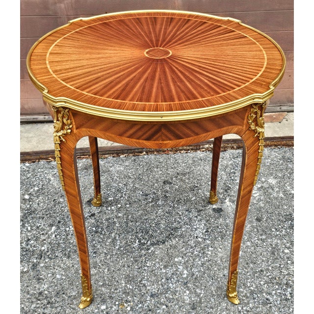 A Louis XV Style Ormolu Gilt Bronze Mounted Kingwood and Tulipwood Gueridons with impressive, clean lines marquetry works...