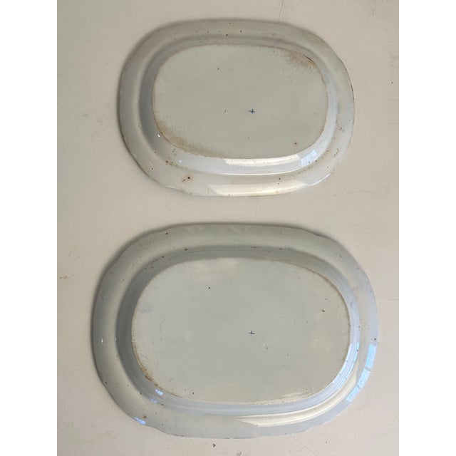 Lovely early 19th century graduated pair of English Staffordshire platters. Images of a herd of fallow deer, a manor...