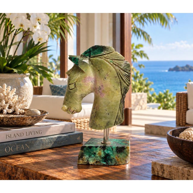 A luxurious hand-carved horse head sculpture from natural emerald-bearing stone, chosen for its exceptional beauty and...