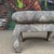 This is a pair of vintage oriental style cushioned ottoman’s covered in a navy and tan peacock patterned fabric.
