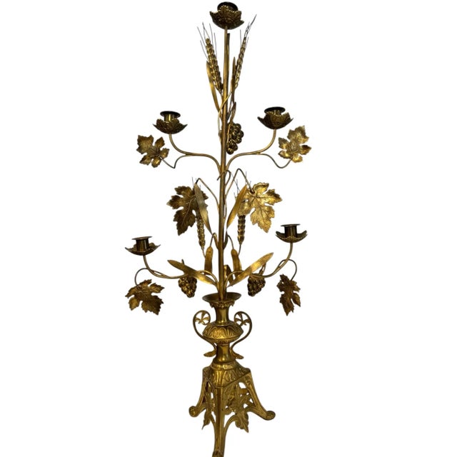 Elegant pair of late 19th century French brass girandoles with intricate grapevine and wheat sheaf motifs symbolizing...