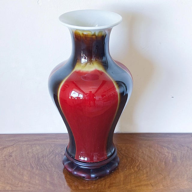 Mid-Century Antique Style Chinese Vase in Red Ox-Blood Flambe Glaze Elegant rosewood base / stand. Measures approx. 14H x...
