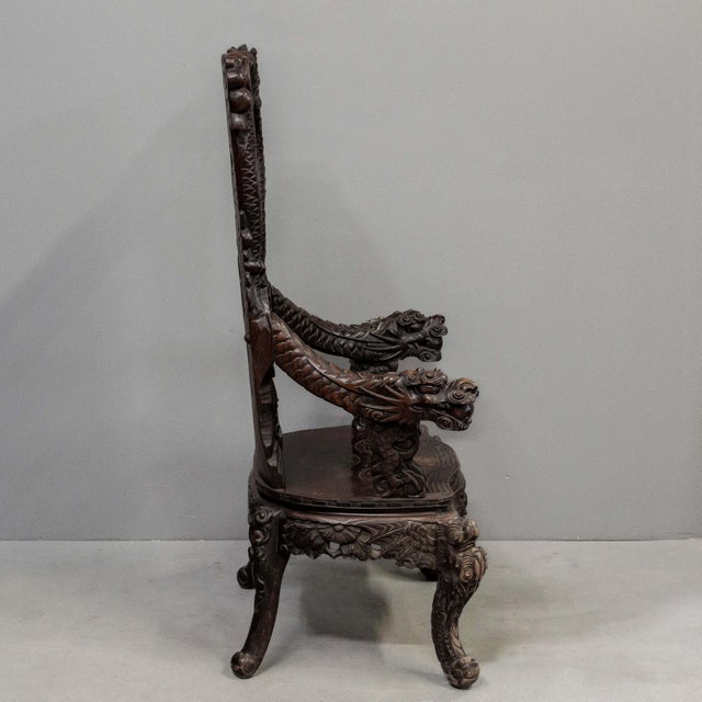 Antique exquisitely carved Japanese high back, red lacquer arm chair featuring dragon head arm rests and monkeys in a...
