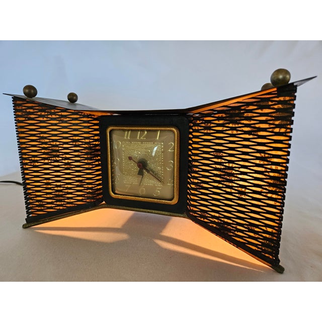 An MCM Atomic Bowtie Clock with Accent Lightning. Runs quiet and keeps good time. All original.