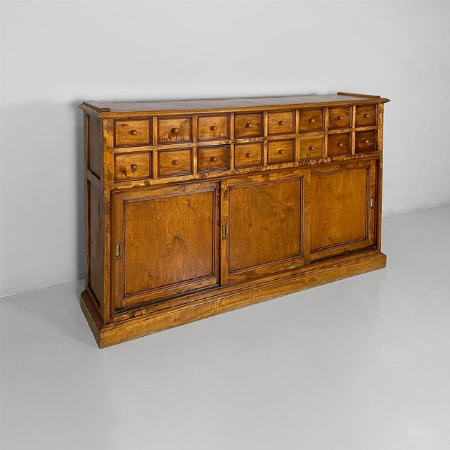 Italian Art Deco wooden sideboard with drawers and compartment, 1930s Sideboard made entirely of solid wood. The upper...