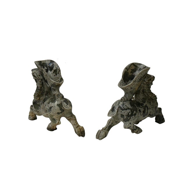 Introduce a timeless aura of historic grandeur into your space with this striking pair of archaistic carved hardstone...