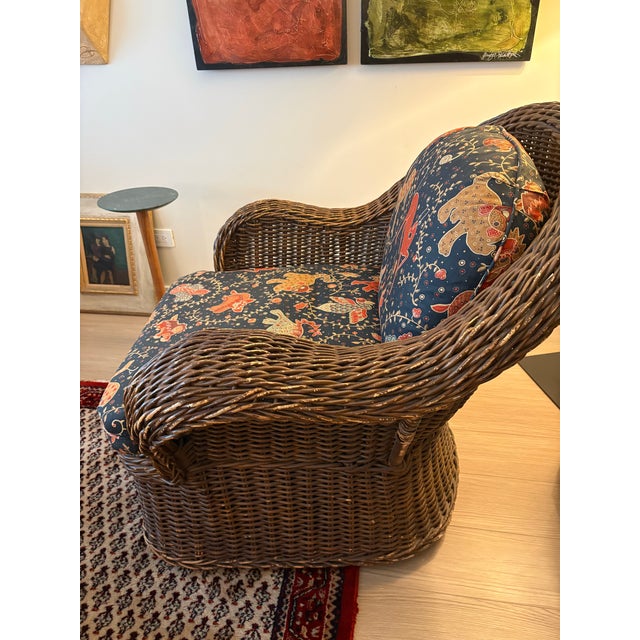 Substantial vintage woven rattan lounge chair featuring a gracefully rounded barrel back, generous rolled arms and deep...