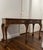 Early to mid 20th century Baker console table with clawfoot design features and carved motifs.