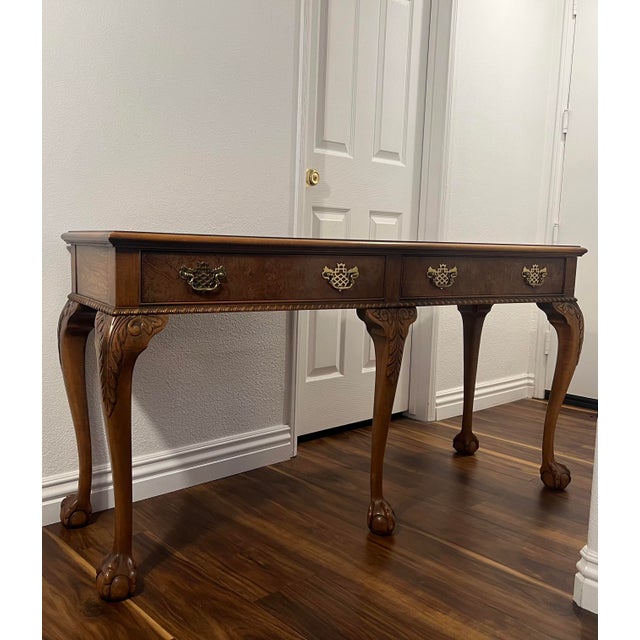 Early to mid 20th century Baker console table with clawfoot design features and carved motifs.