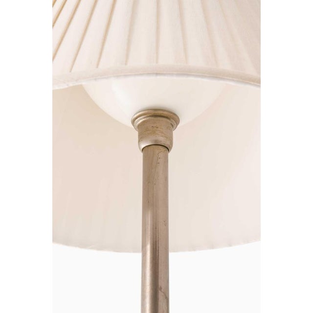 This rare and large table lamp, produced in Sweden during the 1940s, is an elegant example of transitional design,...