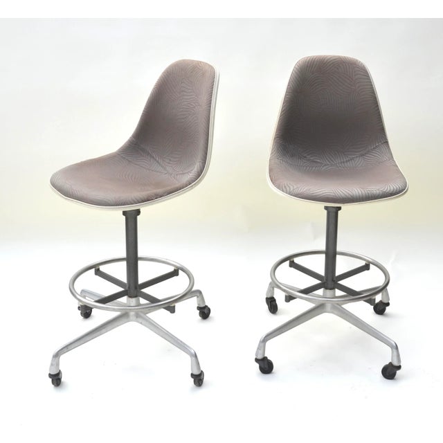 A mid century modern drafting stools designed by Charles and Ray Eames and made by Herman Miller. Eames Aluminum Group or...