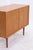 Vintage teak chest of drawers with a clean front, two doors and a spacious interior compartment. The slender tapered legs...