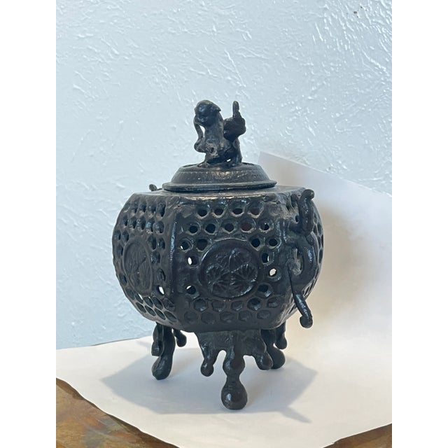 This black color incense burner is made of a bronze mix material, It has carved Foo Dog on lid and flowers around the...