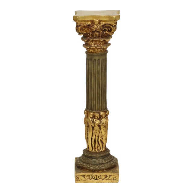 Classic gold-colored column, pillar, or pedestal, made entirely of cast resin, popularly known as resin, a heavy object...
