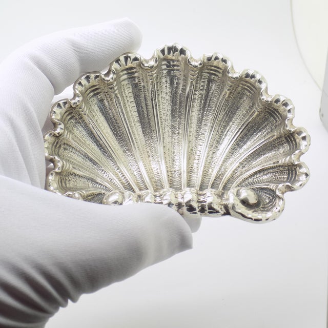 This vintage silver decorative tray depicts a naturalistic sea shell, crafted as a entry hall key bowl, trinket dish, or...