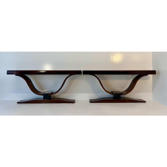 Striking pair of French Art Deco consoles dating from circa 1940s, distinguished by their elegant architectural...