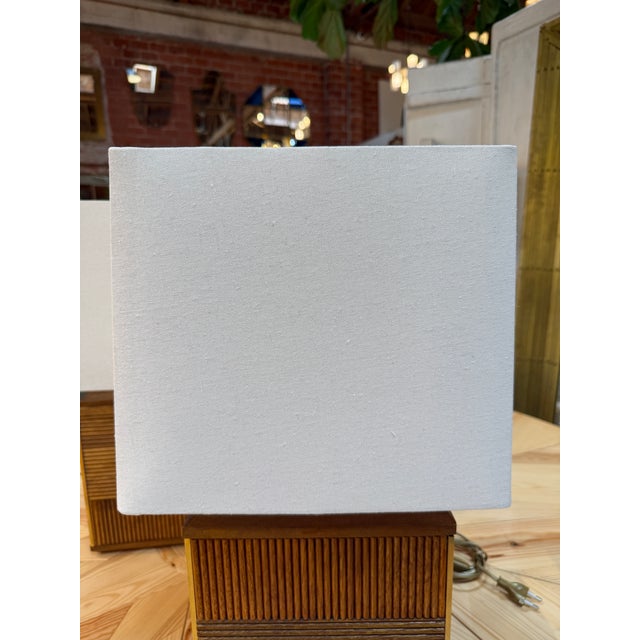 A distinctive pair of Italian Mid-Century Modern table lamps featuring architectural cube-shaped wooden bases decorated...