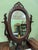 A stunning Victorian rosewood three-drawer dresser with oval swivel mirror. The mirror has an ornate scalloped frame and...
