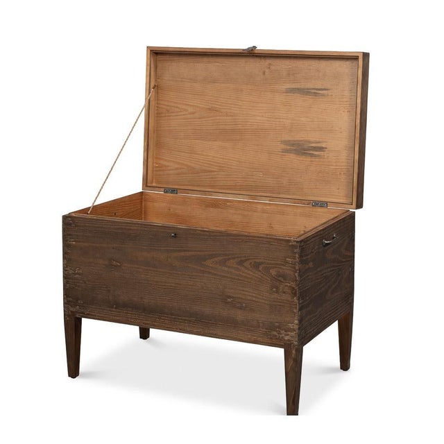 A hinged lid lifts to reveal concealed storage beneath the tabletop. That single fact separates it from every other table...