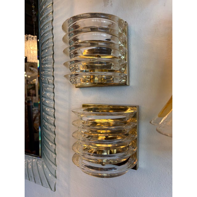 Vintage pair of Art Deco lucite ribbon & brass wall light sconces. Uplighting position of the bulb. May have slight patina...