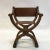 Mid-20th century, craftsman, Campaign or prayer chair features a carved cherry frame with newly upholstered luggage tan...