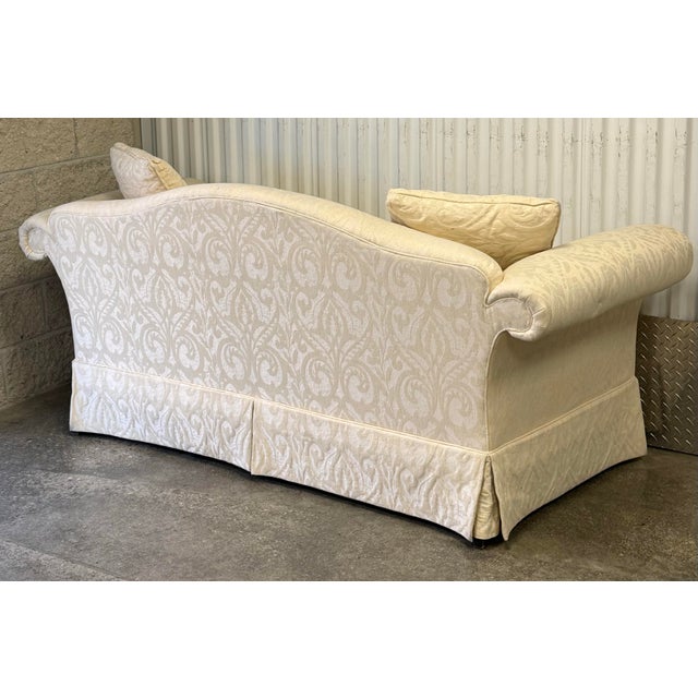 Beautiful upholstered loveseat by Robb and Stucky. Features a neutral cream color tonal upholstery, rolled arms, tight...