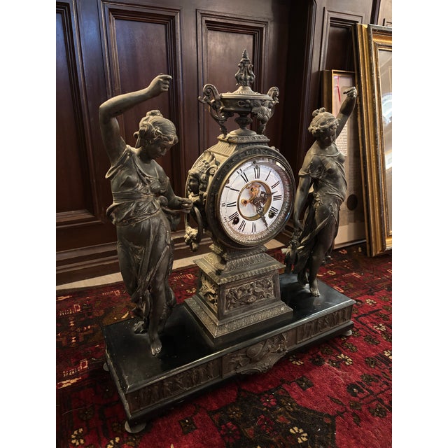 Stunning antique Ansonia “Huntress and Fisher” figural mantel clock, featuring two beautifully detailed classical figures...