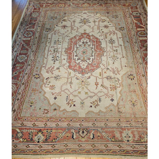 This oversize vintage Turkish Oushak rug from the early 20th century is an exceptional piece of Anatolian weaving in a...