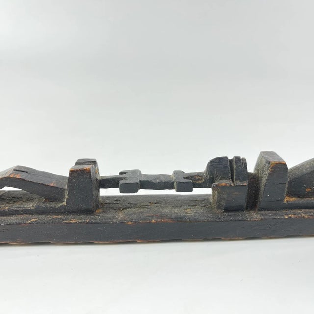 This fragment of a carved wooden scepter originates from the Dogon people of Mali. Traditionally used in rituals and by...