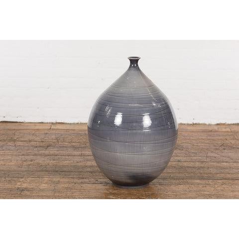 A contemporary Prem Collection artisan hand crafted ceramic vase with narrow mouth, blue grey glaze and striated effects....
