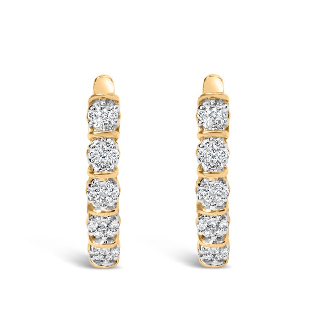 Imbued with an irresistible charm and crafted in resplendent 14k yellow gold, these exquisite hoop earrings are treasures...