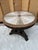 Beautiful round center table with a marble inlay top in a sunburst design. The stone pieces show a mix of natural shades...