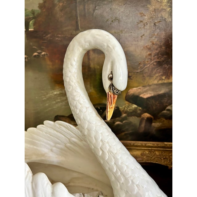 A striking oversized ceramic swan jardinière, beautifully modeled with an elegantly arched neck, finely detailed plumage,...