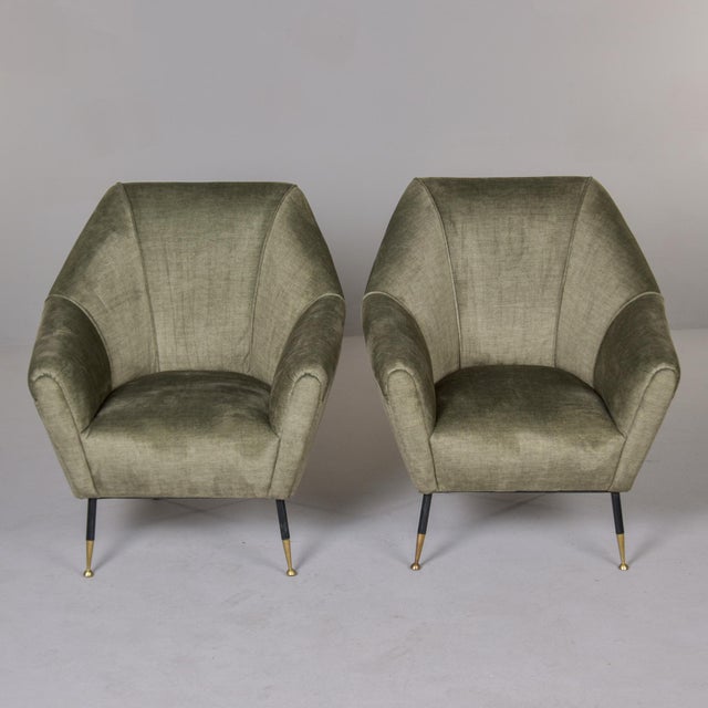 Found in Italy, this pair of upholstered armchairs dates from the 1960s. Chairs have a distinct shape that bridges both...