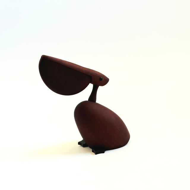 A mid century turned wood figurine in the shape of a Pelican. Adorable stylized features. Made in Japan by Senshukai as...