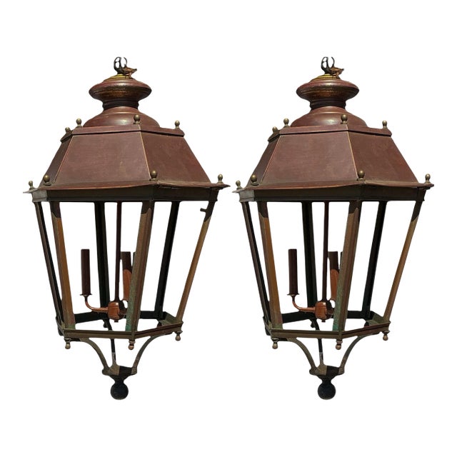 This is a pair of rustic French three light copper and brass lanterns.The wiring is new. They have three interior lights....