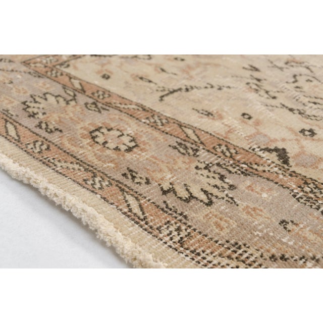 This is a vintage Turkish Oushak rug from the 1960s. The piece was hand-knotted.