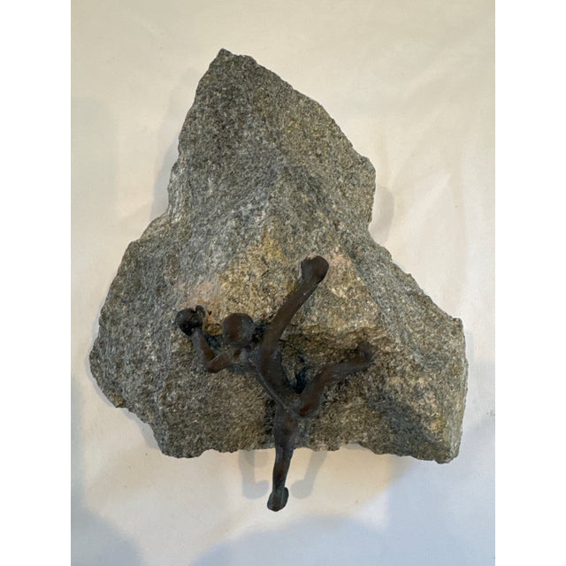 Bold and evocative, this wall-mounted bronze sculpture captures the essence of determination and ascent. A minimalist rock...